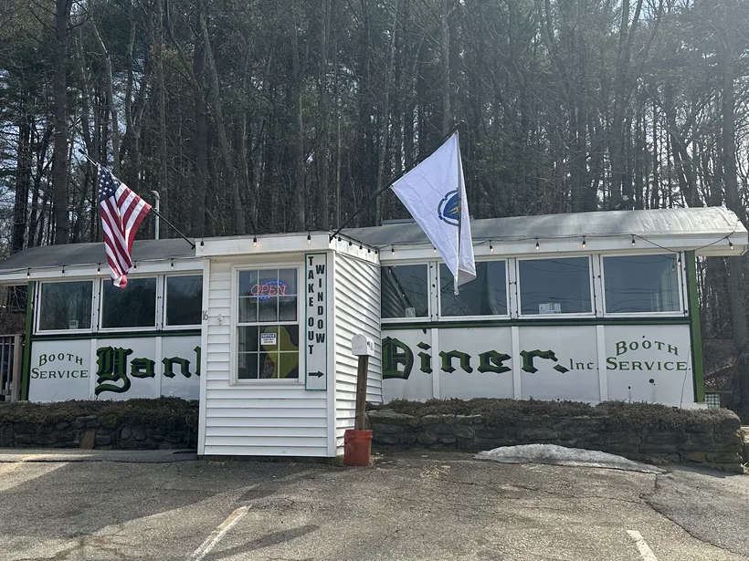 The diner from the parking lot, its white clapboard and barrel roof low against the treeline on Worcester Road.